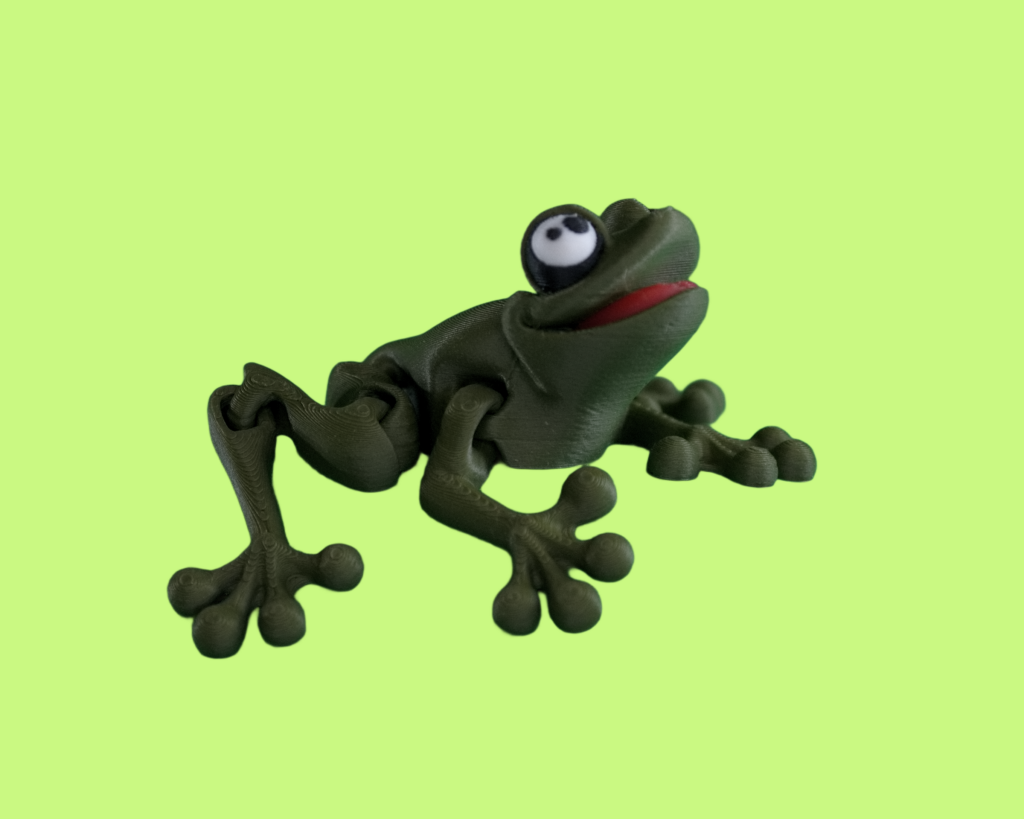 Photo of 3D printed frog in dark green on a light green background.